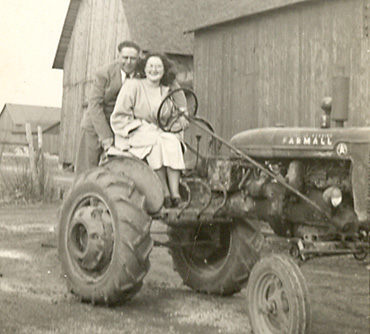 Lawrence and Catherine (Pothast) Lucas on Farmall A tractor