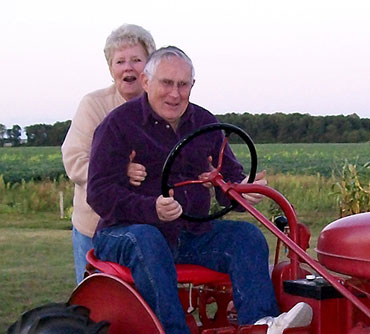 Jerry and Geraldine Schmeltz on Farmall A tractor 2009